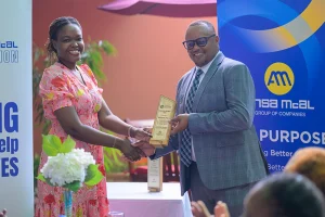 ANSA McAL Country Head Troy Cadogan presents Leanna Thompson of Blossom Inc.
with the NGO’s Social Investment Award
