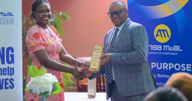 ANSA McAL Country Head Troy Cadogan presents Leanna Thompson of Blossom Inc.
with the NGO’s Social Investment Award